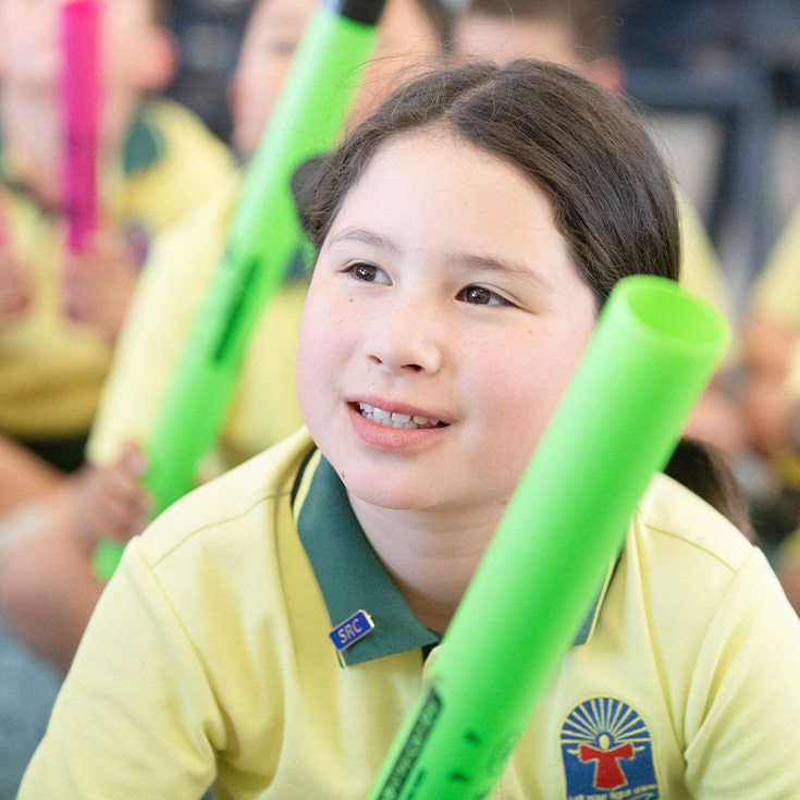 Student smiling in the classroom at St Angela's Primary School Castle Hill