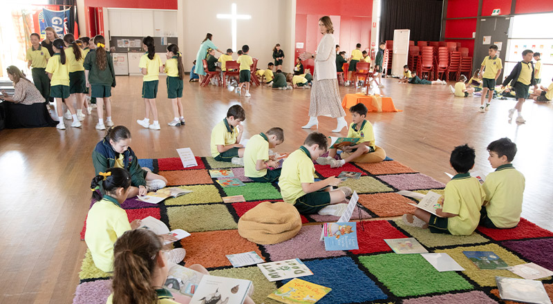 Students reading together during class at St Angela's Primary School Castle Hill