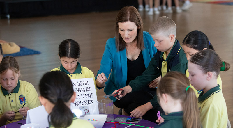 Teacher with her students during a Religion class at St Angela's Primary School Castle Hill