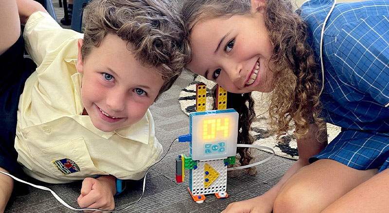 Students building a robot together in the classroom at St Angela's Primary School Castle Hill