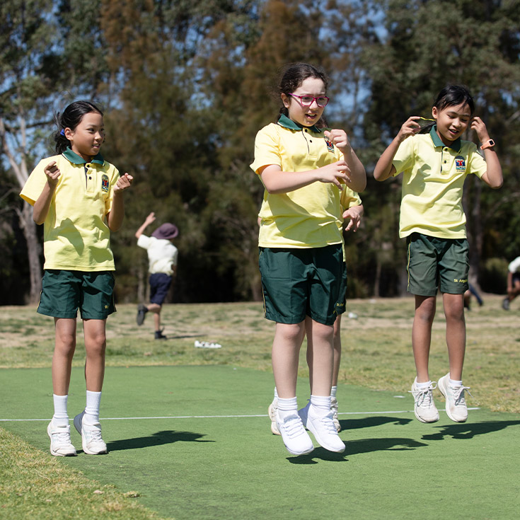 Students performing a dance on the school oval at St Angela's Primary School Castle Hill